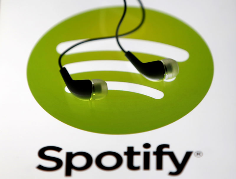 © Reuters. Earphones are seen on a tablet screen with a Spotify logo on it, in Zenica