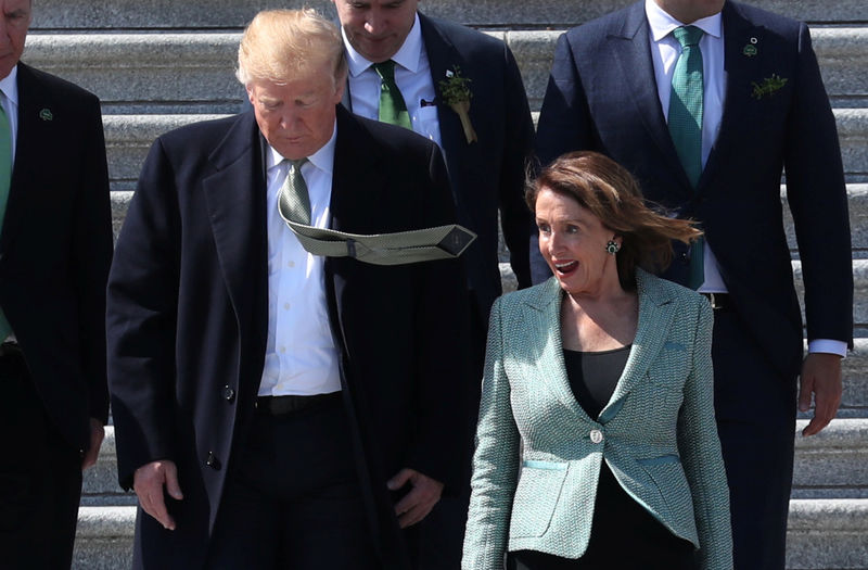 © Reuters. U.S. President Trump walks down Capitol steps with Speaker of the House Pelosi after they attended luncheon at U.S. Capitol in Washington