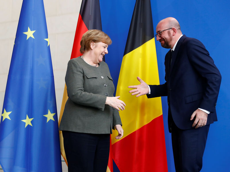 © Reuters. Prime Minister of Belgium Charles Michel and German Chancellor Angela Merkel shake hands at the end of their news conference at the Chancellery in Berlin