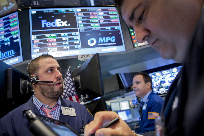 © Reuters. FILE PHOTO: Traders work at the post that trades FedEx on the floor of the New York Stock Exchange