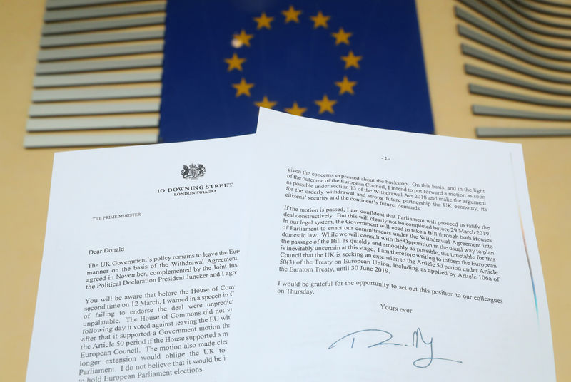 © Reuters. A copy of the letter sent by British Prime Minister Theresa May to European Council President Donald Tusk is seen next to an European Flag in this illustration picture