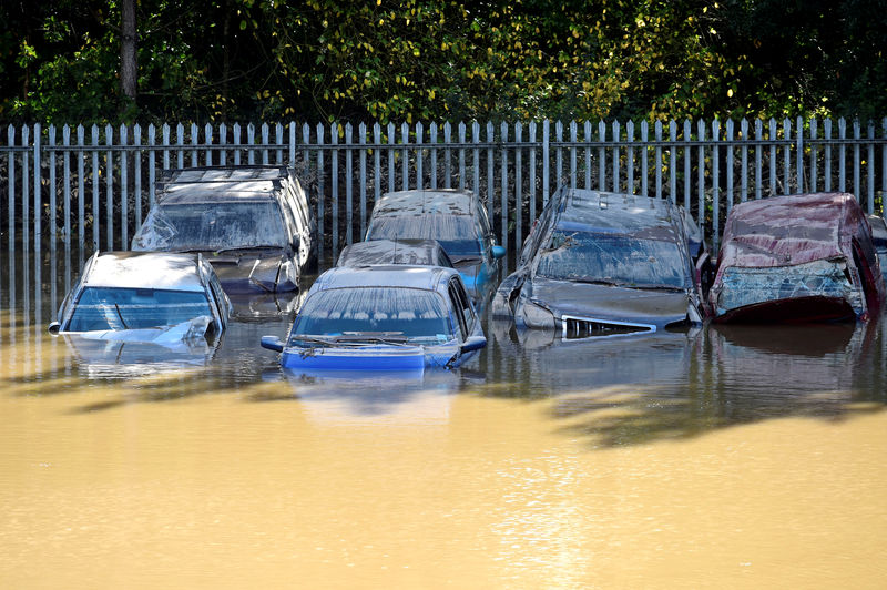 © Reuters. FILE PHOTO: Cars caught in flood water after Storm Callum passed through the town of Carmarthen, west Wales