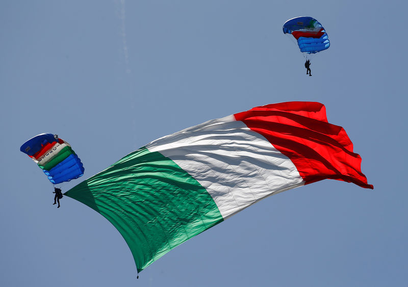 © Reuters. An Italian Army parachutist hoists Italian flag during the Republic Day military parade in Rome