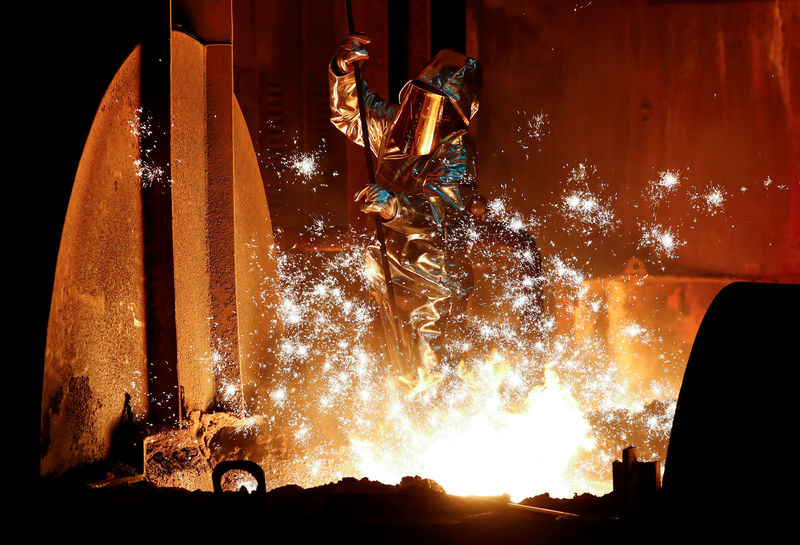 © Reuters. FILE PHOTO: A steel worker of Germany's ThyssenKrupp AG takes a sample of raw iron from a blast furnace in Duisburg
