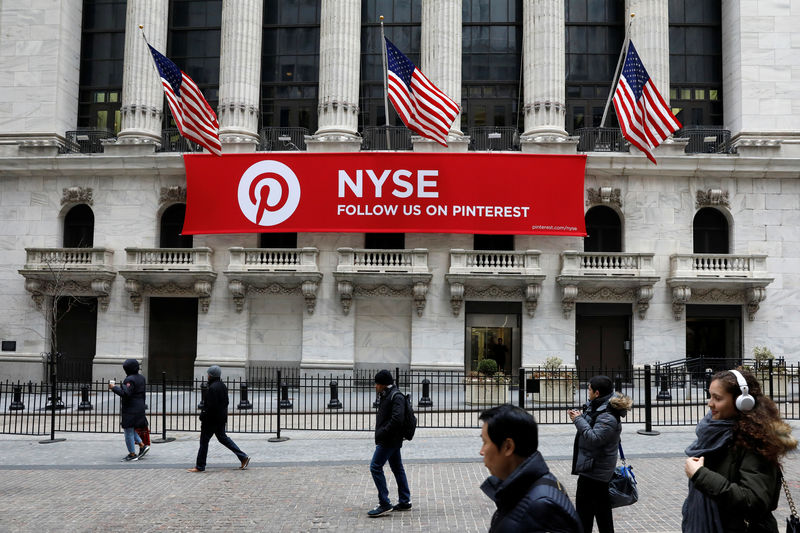 © Reuters. FILE PHOTO: A Pinterest banner hangs on the facade of the New York Stock Exchange, (NYSE) during the morning rush in the financial district in New York