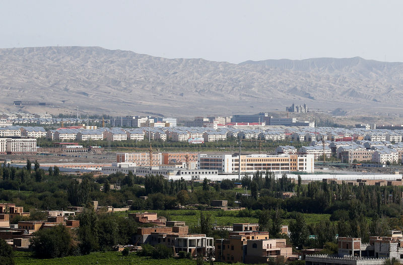 © Reuters. FILE PHOTO: With Xinjiang’s fabled Tianshan mountains in the background, what is officially known as a vocational skills education centre is seen in Turpan