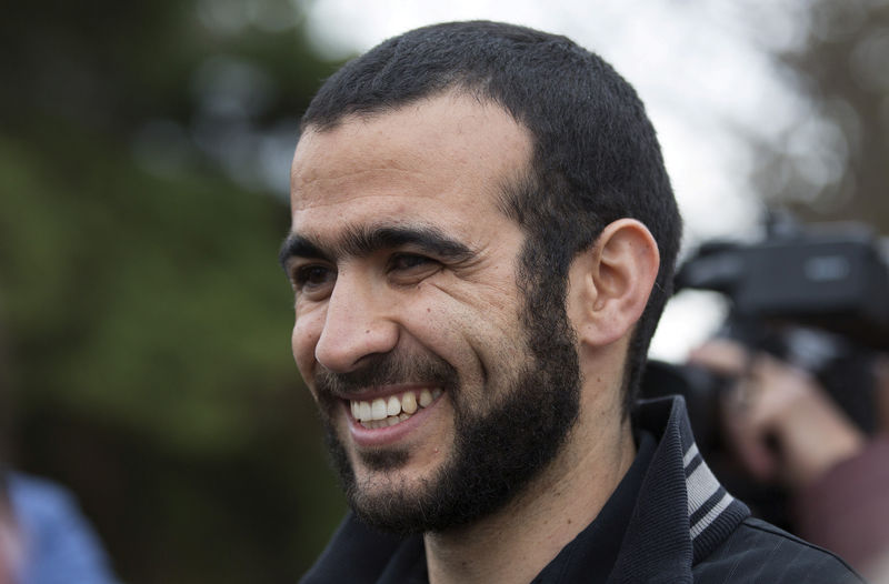 © Reuters. FILE PHOTO: Omar Khadr smiles as he answers questions during a news conference after being released on bail in Edmonton, Alberta