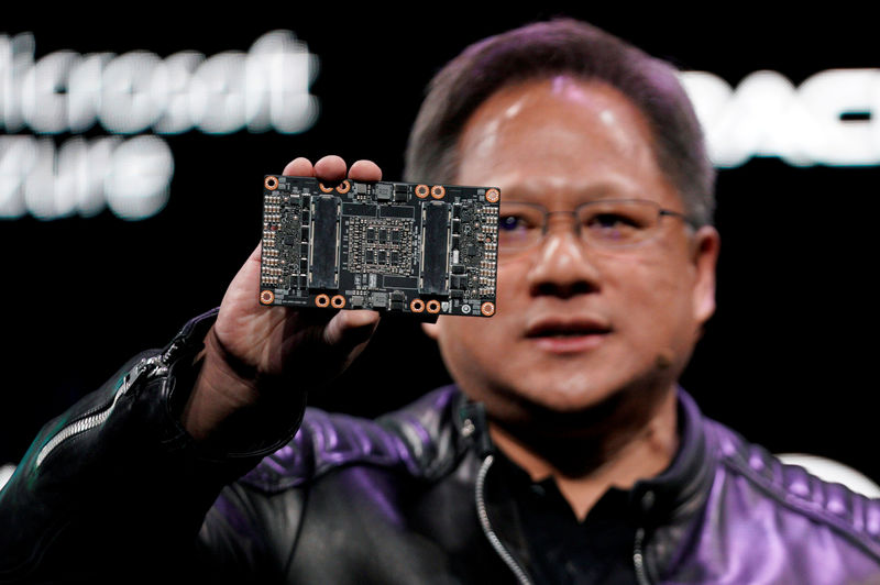 © Reuters. FILE PHOTO: Jensen Huang, CEO of Nvidia, shows the NVIDIA Volta GPU computing platform at his keynote address at CES in Las Vegas