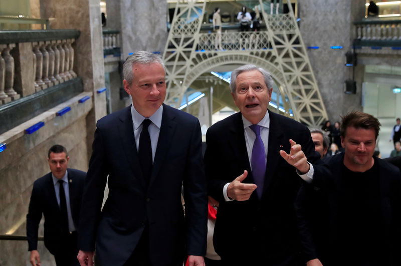 © Reuters. French Finance and Economy Minister Bruno Le Maire and Galeries Lafayette group Executive Chairman Philippe Houze visit the new Galeries Lafayette flaghip store on the Champs Elysees avenue in Paris