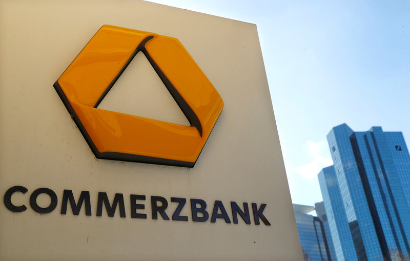 © Reuters. A sign for an ATM of Commerzbank is seen next to the headquarters of Deutsche Bank (R) in Frankfurt