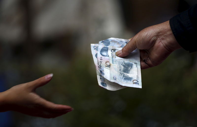 © Reuters. A vendor selling flowers hands over change to a customer in Kunming