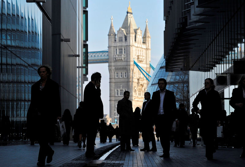 © Reuters. FILE PHOTO - Office workers are seen in the London Place business district near Tower Bridge in central London