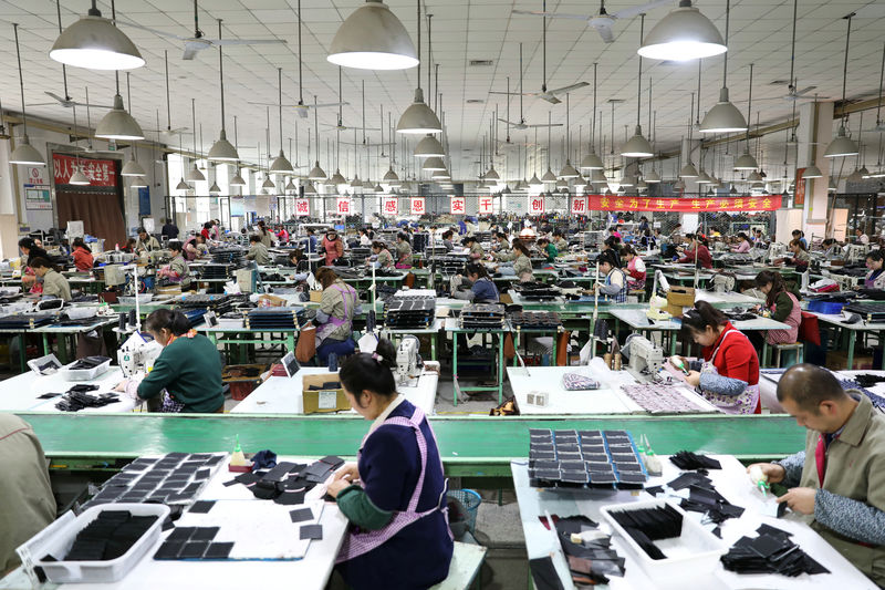 © Reuters. Employees work on the production line of a factory manufacturing fashion accessories in Sihong