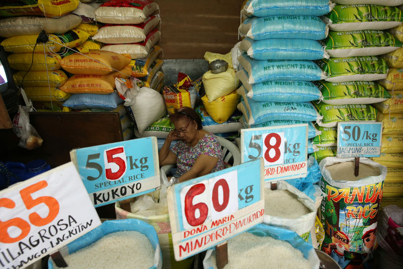 © Reuters. A vendor rests in her market stand that sells rice in Quezon City