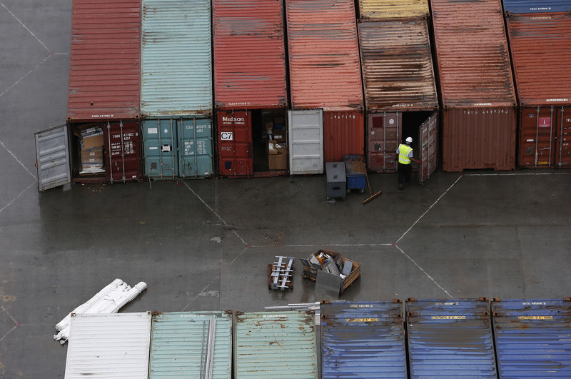 © Reuters. A worker opens the door of a container at DP World London Gateway container port in Essex, southern England