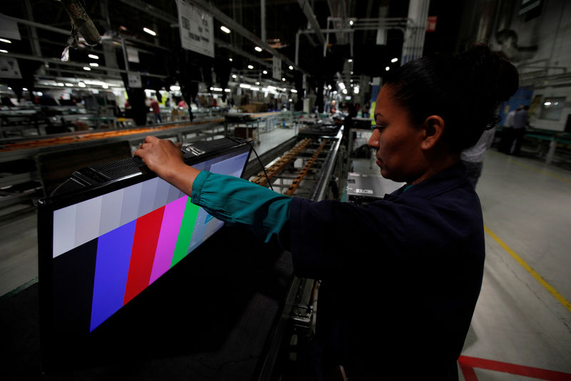 © Reuters. FILE PHOTO: An employee works at an LED TV assembly line at a factory that exports to the U.S. in Ciudad Juarez