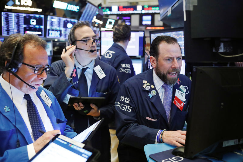 © Reuters. FILE PHOTO: Traders work on the floor of the New York Stock Exchange (NYSE) shortly after the opening bell in New York