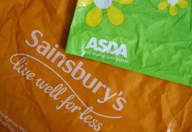 © Reuters. FILE PHOTO: Shopping bags from Asda and Sainsbury's are seen in Manchester.