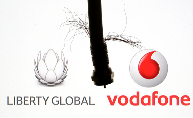 © Reuters. FILE PHOTO:  Coaxial TV Cable is seen in front of Vodafone and Liberty Global logos in this illustration