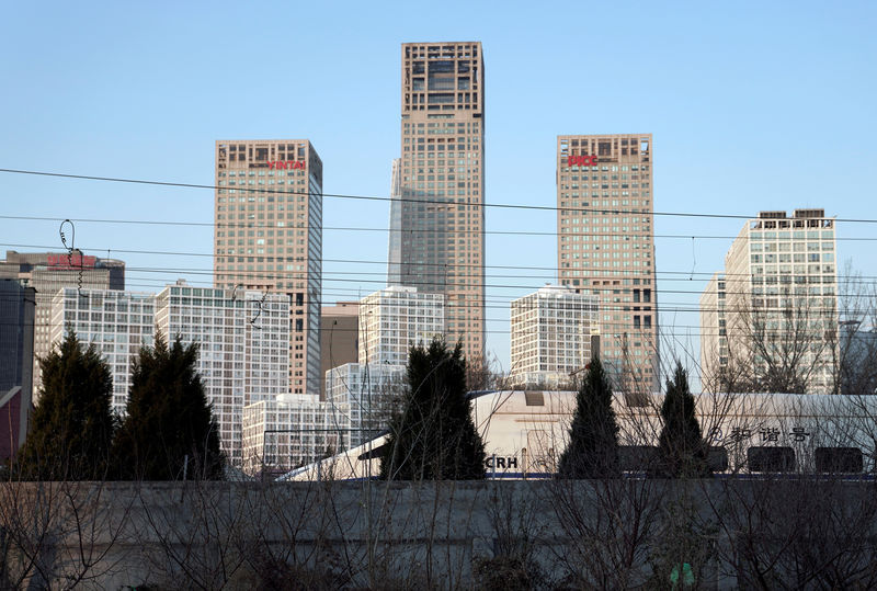 © Reuters. FILE PHOTO: A CRH bullet train runs past Beijing's central business area