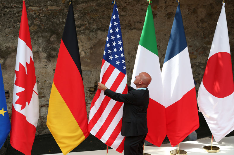 © Reuters. Flags are placed at the G7 summit in Taormina