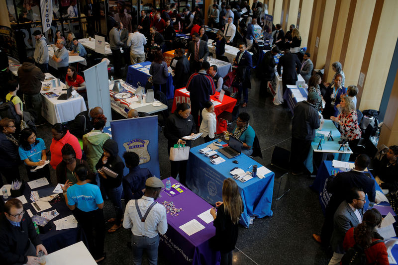 © Reuters. FILE PHOTO:  Job seekers speak with potential employers at a City of Boston Neighborhood Career Fair on May Day in Boston