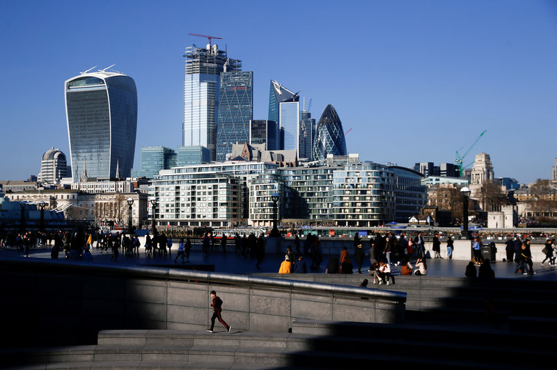 Â© Reuters. FILE PHOTO: The financial district can be seen as a person runs in the sunshine on London's south bank