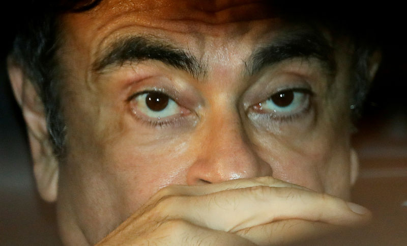 © Reuters. FILE PHOTO: Former Nissan Motor Chairman Carlos Ghosn sits inside a car as he leaves his lawyer's office after being released on bail from Tokyo Detention House, in Tokyo