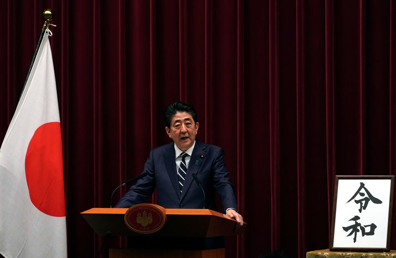 © Reuters. FILE PHOTO: Japan's Prime Minister Shinzo Abe delivers a press conference standing next to the calligraphy 'Reiwa' which was chosen as the new era name at the prime minister's office in Tokyo