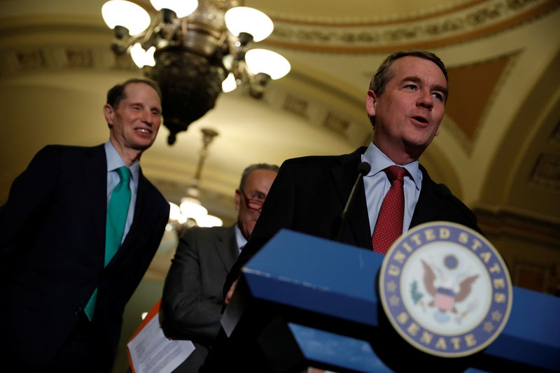 © Reuters. Senator Michael Bennet, accompanied by Senator Ron Wyden, speaks with reporters following the party luncheons on Capitol Hill in Washington