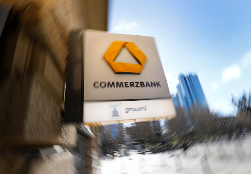 © Reuters. FILE PHOTO: A sign for an ATM of Commerzbank is seen next to the headquarters of Deutsche Bank (R) in Frankfurt