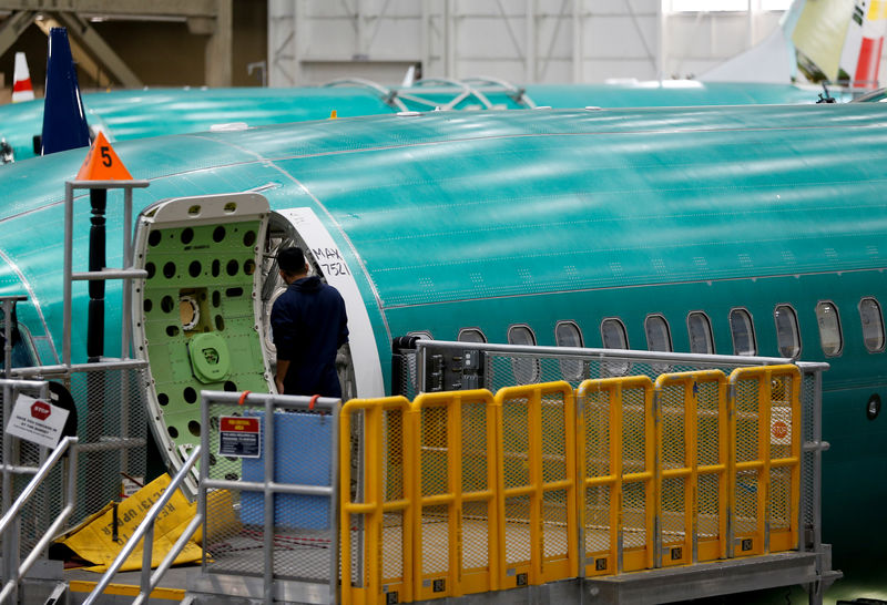 © Reuters. An employee enters a 737 Max aircraft at the Boeing factory in Renton