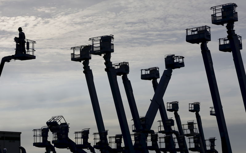 © Reuters. File photo of a worker standing on a crane which is parked at a construction site at Keihin industrial zone in Kawasaki