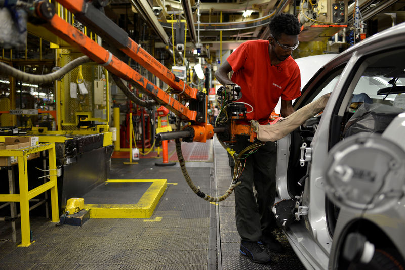 © Reuters. FILE PHOTO: A line worker installs the front seats on the flex line at Nissan Motor Co's automobile manufacturing plant in Smyrna Tennessee