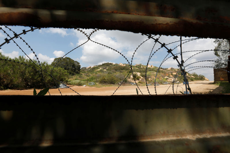 © Reuters. Razor barbed wire is seen through the border fence on the U.S. territory, seen from Tecate