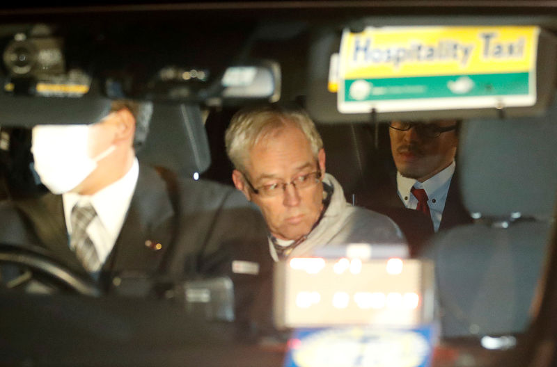 © Reuters. FILE PHOTO - Greg Kelly, the former deputy of ousted Nissan chairman Carlos Ghosn, is seen in the car, as he leaves after being released from a detention centre in Tokyo