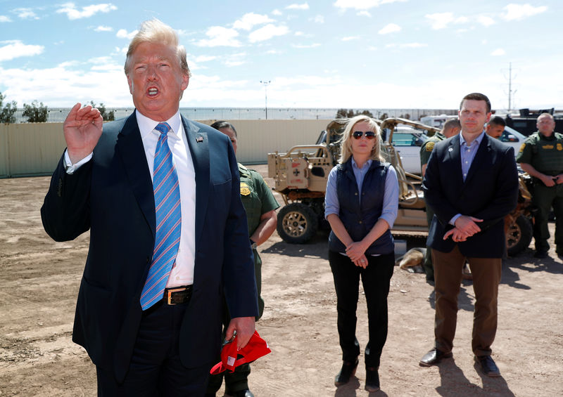 © Reuters. FILE PHOTO: Neilsen and McAleenan listen to Trump at border security tour in California