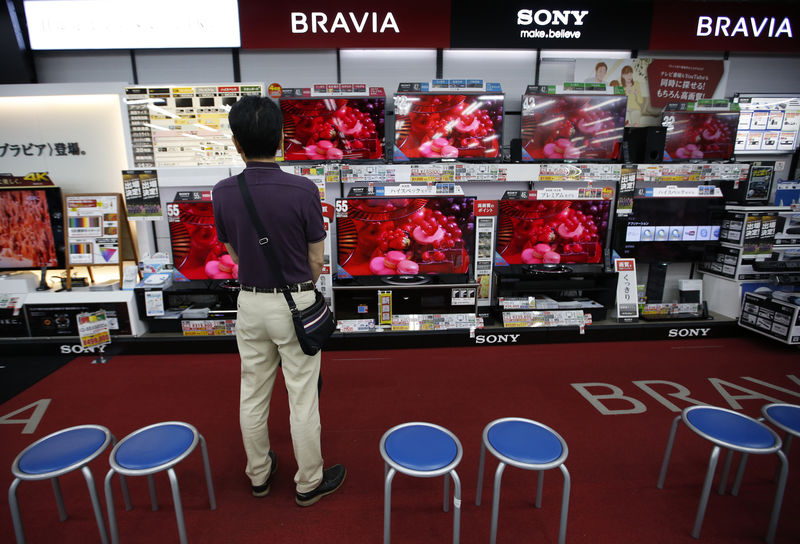 © Reuters. FILE PHOTO: A shopper looks at Sony Corp's Bravia television monitors at an electronics store in Tokyo