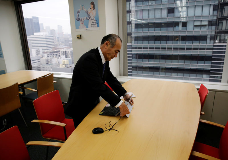 © Reuters. Yasuhiro Furuse, a senior adviser of corporate sales headquarters of Orix Corp., unfolds his laptop at a meeting room in Tokyo