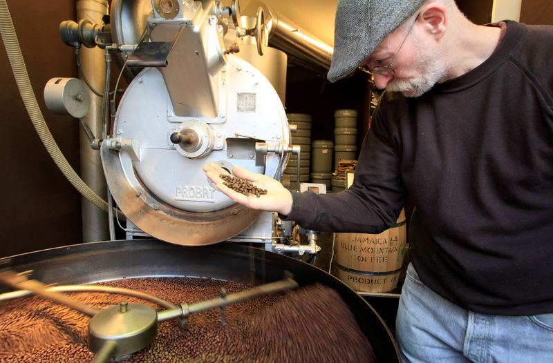 © Reuters. FILE PHOTO: An employee checks freshly roasted coffee beans at H. Schwarzenbach coffee roastery in Zurich