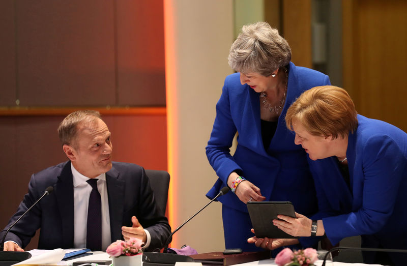 © Reuters. Premiê britânica, Theresa May, e chanceler alemã, Angela Merkel, conversam com presidente do Conselho Europeu, Donald Tusk, durante reunião do órgão em Bruxelas