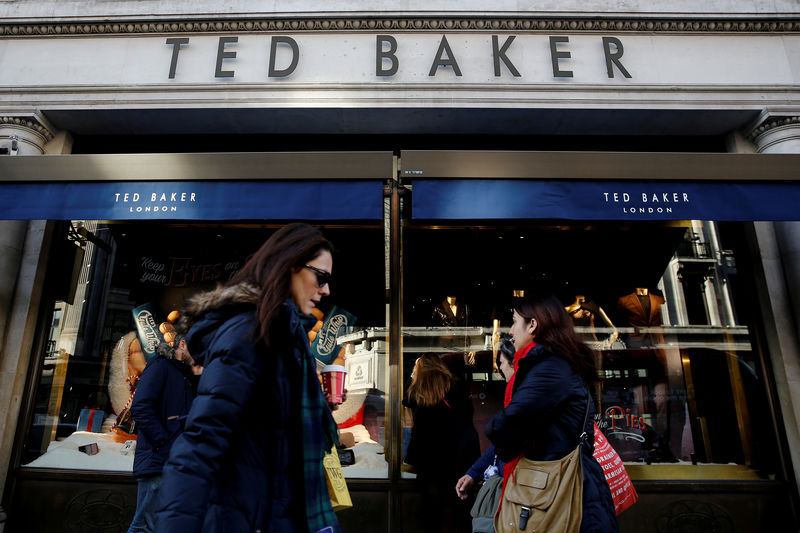 © Reuters. FILE PHOTO: Shoppers walk past a Ted Baker store on Regents Street in London