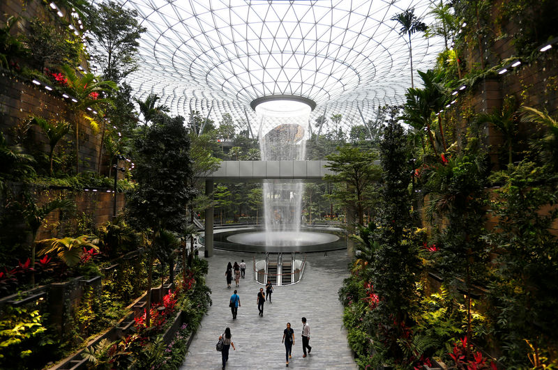 © Reuters. The 40-metre high Rain Vortex, which is the world's tallest indoor waterfall, is seen from inside Jewel Changi Airport in Singapore
