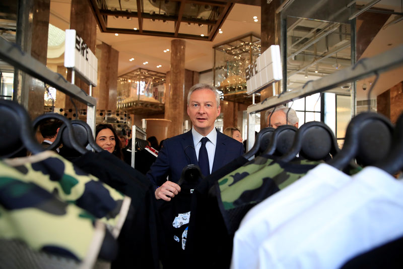 © Reuters. FILE PHOTO: French Finance and Economy Minister Bruno Le Maire visits the new Galeries Lafayette flaghip store on the Champs Elysees avenue in Paris