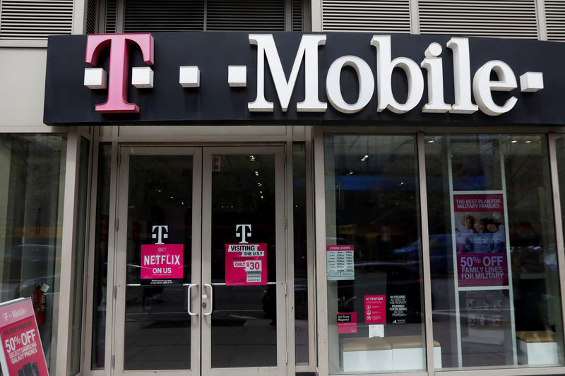 © Reuters. FILE PHOTO: A sign for a T-Mobile store is seen in Manhattan, New York