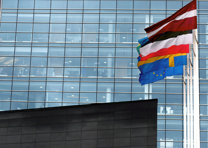 © Reuters. FILE PHOTO: Flags flutter next to the Swedbank Latvian head office in Riga