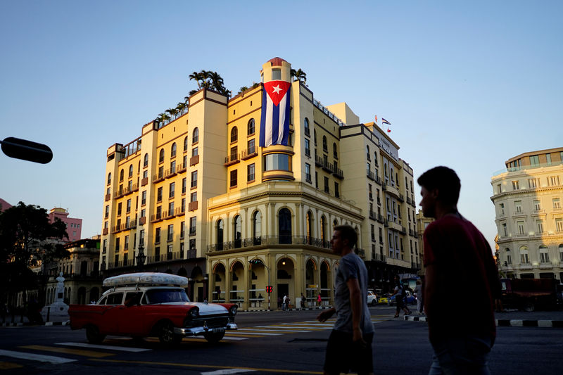 © Reuters. FILE PHOTO: A Cuban flag hangs outside a hotel in Havana