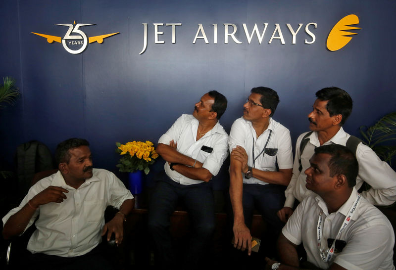 © Reuters. Jet Airways employees sit at the front desk at its headquarters in Mumbai