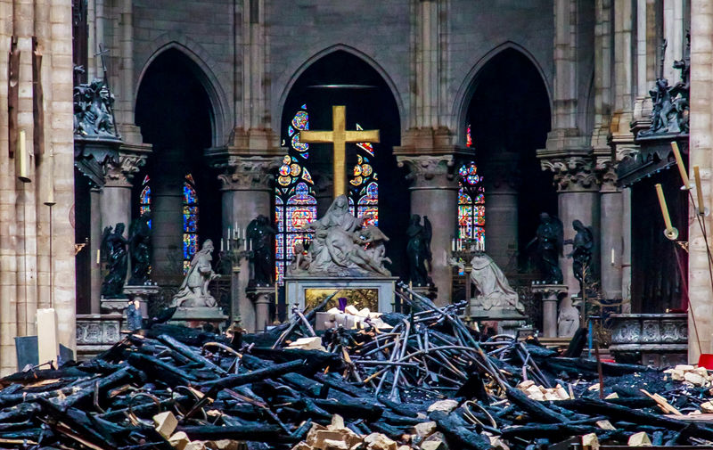 © Reuters. A view of the cross and sculpture of Pieta by Nicolas Coustou in the background of debris inside Notre-Dame de Paris, in the aftermath of a fire that devastated the cathedral, during the visit of French Interior Minister Christophe Castaner in Paris