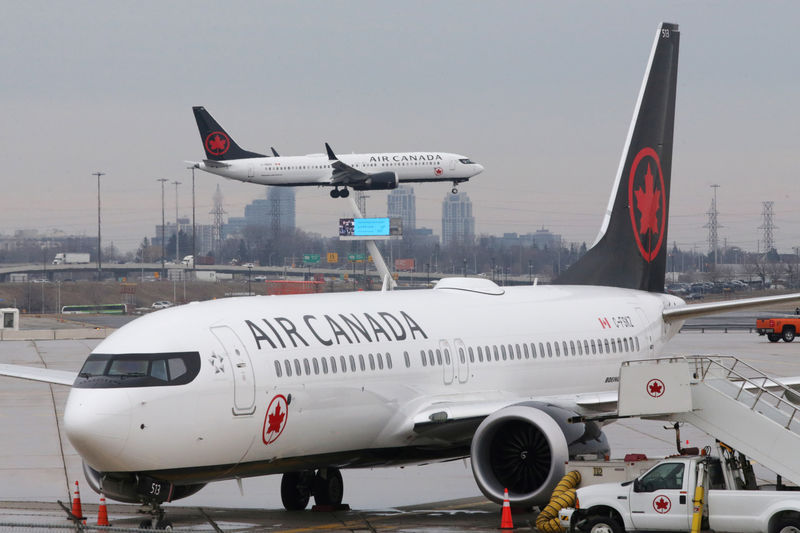 © Reuters. An Air Canada Boeing 737 MAX 8 from San Francisco approaches for landing at Toronto Pearson International Airport over a parked Air Canada Boeing 737 MAX 8 aircraft in Toronto